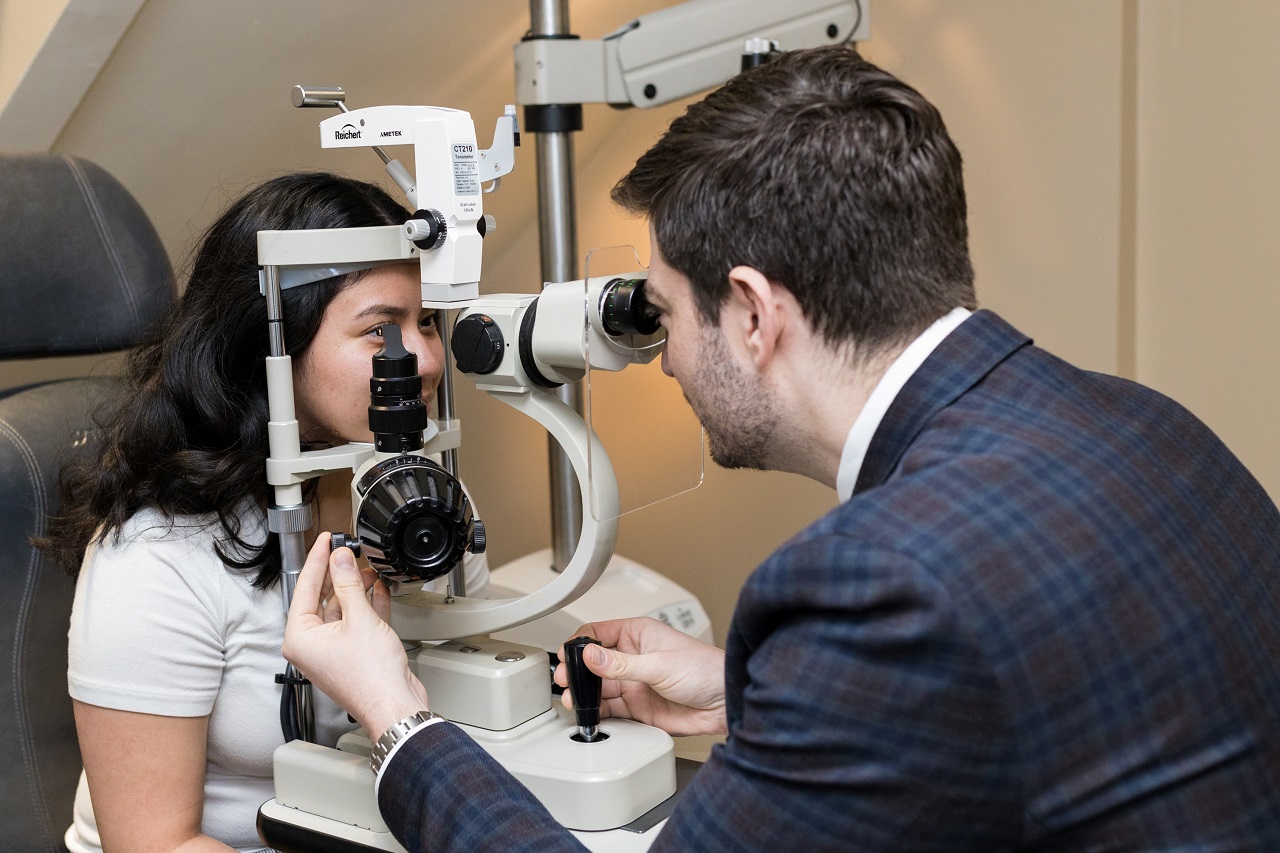 Optometrist examining patient eyes