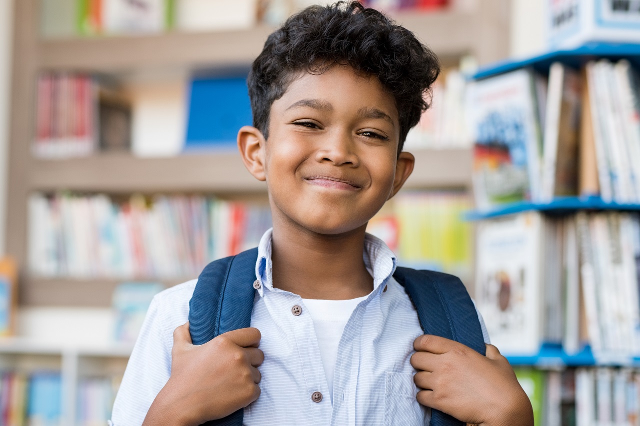 happy hispanic boy at school